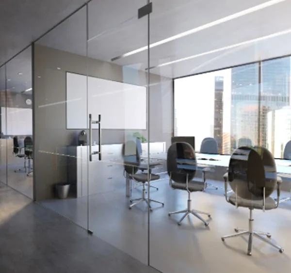 Modern office, with large glass windows, looking out towards city scene.