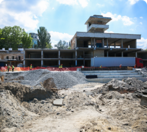 Outside view of a commercial jobsite, with construction workers.