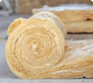 roll of yellow fiberglass insulation, layed out on the floor.