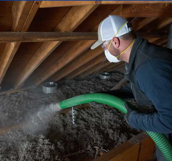 Cellulose Insulation Installer, insulating an attic.