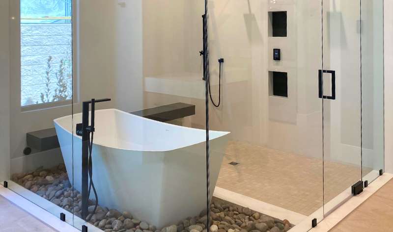 Frameless shower door install in home’s bathroom. Frameless shower door install in home's bathroom.