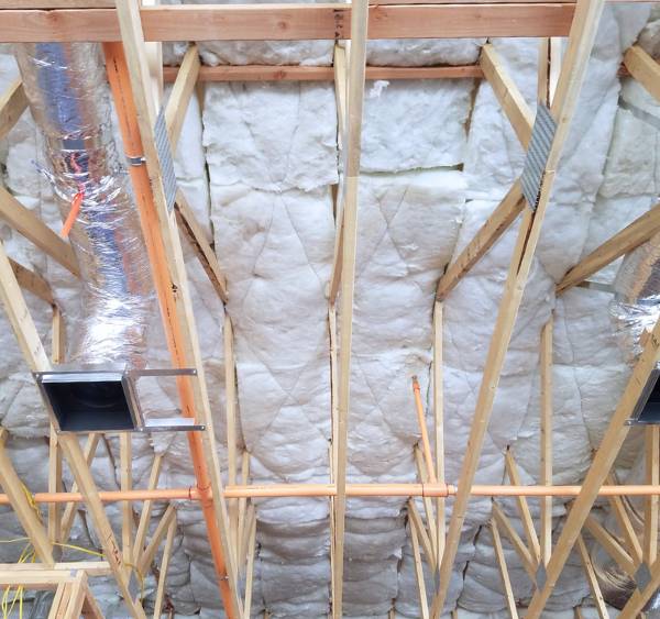 Batt insulation installation in building. Batt insulation installation in building.