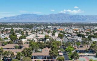 Aerial view across urban suburban communities in Las Vegas Nevada with streets, rooftops, and homes
